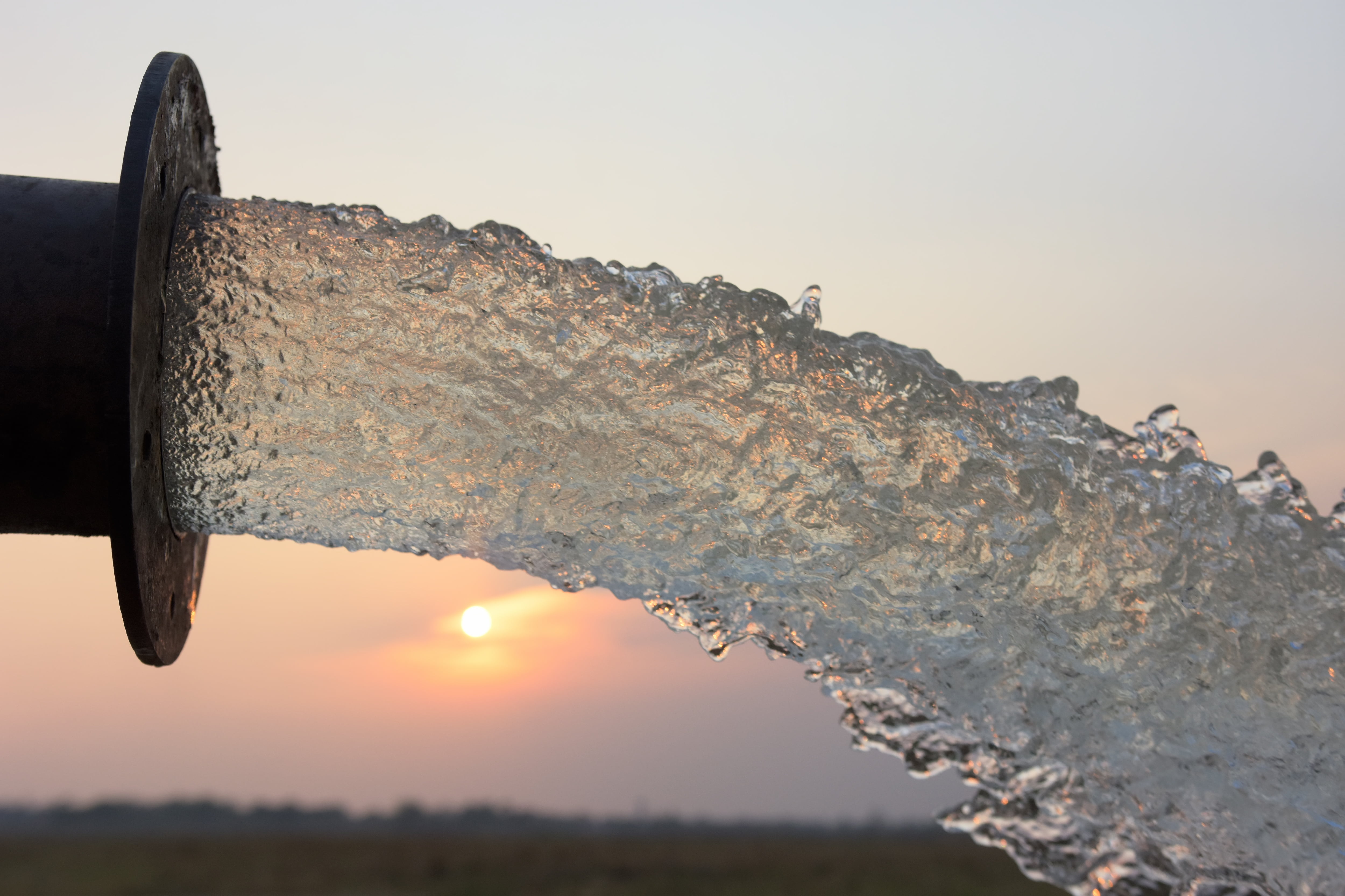 Water Flow From Pipe, and Sunset